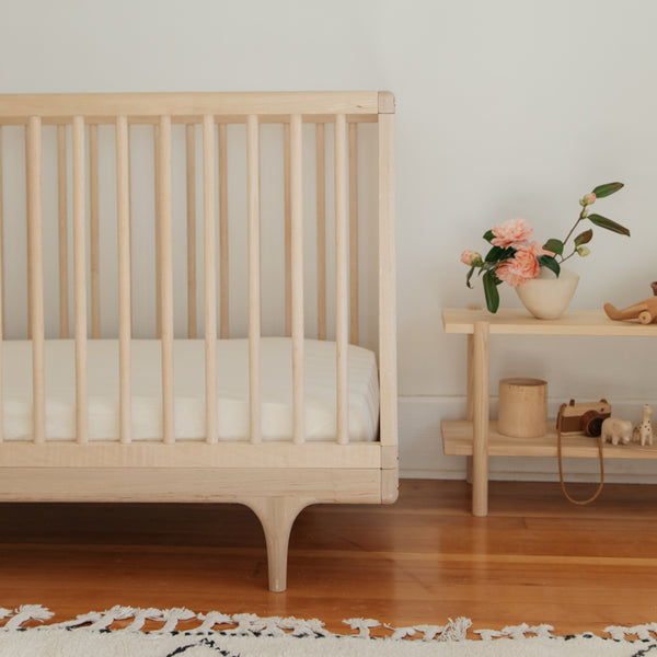 cream nursery with crib and floral decor