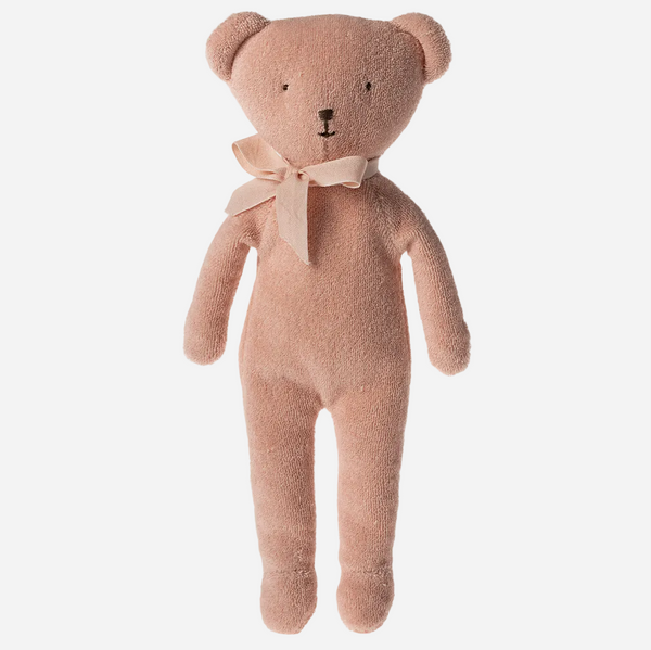 Pink teddy bear with a bow tie on a white background