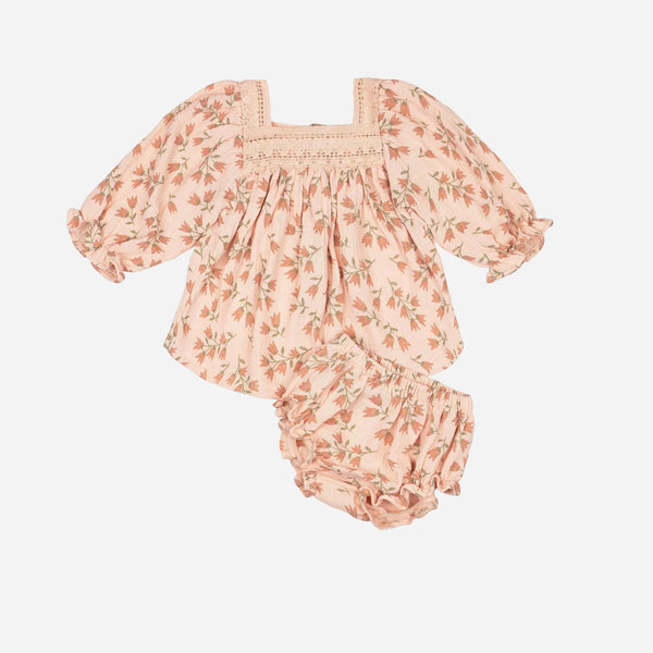 Floral baby outfit with top and bloomers on a white background