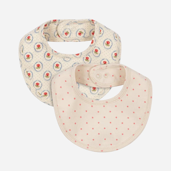 Two baby bibs with floral and polka dot patterns on a white background
