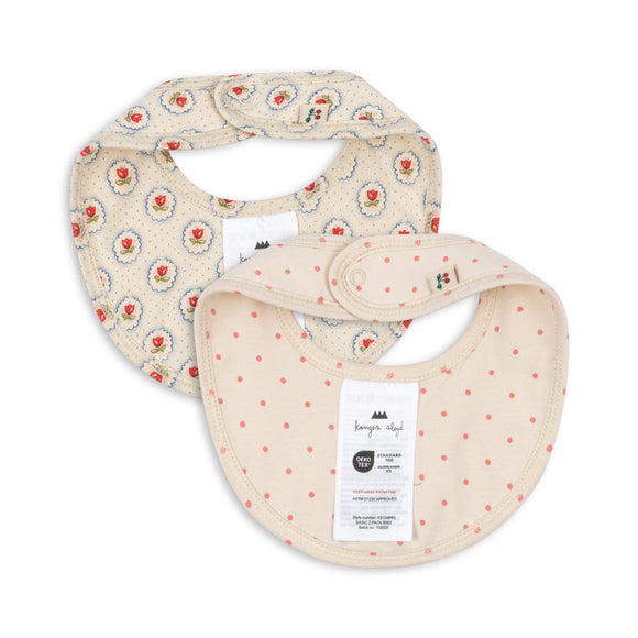Two baby bibs with floral and polka dot patterns on a white background
