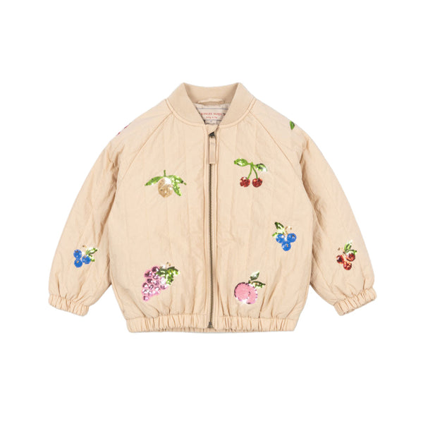 Beige jacket with sequined fruit designs on a beige background