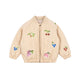 Beige jacket with sequined fruit designs on a beige background