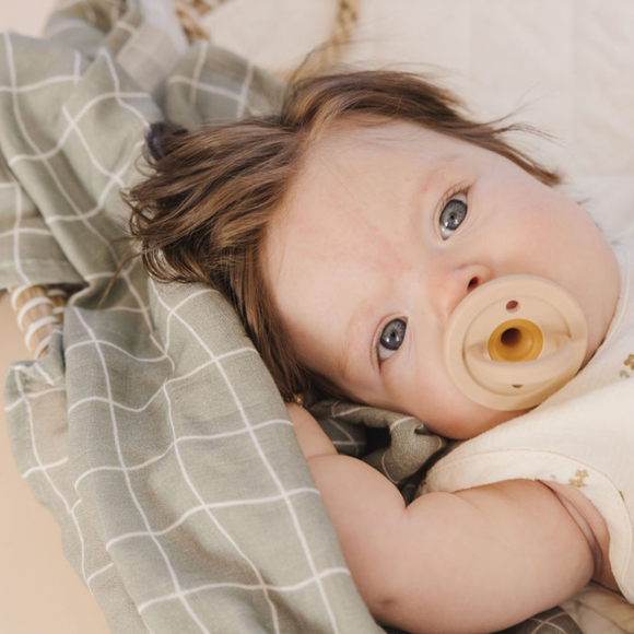 Baby with Organic Muslin Swaddle Blanket in Christina Grid Print